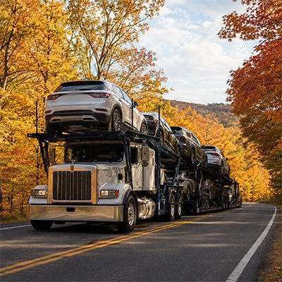 Car carrier under autumn foliage